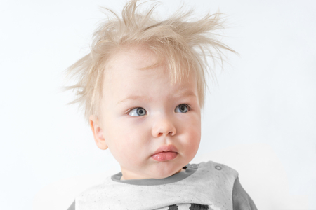 cute sleepy disheveled child with interrogative face.の写真素材