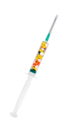 syringe filled with dose of medication pills and colored capsules isolated on white background. drug therapy injection per patient. healthcare, treatment, preservation of health and medical concepts.の写真素材