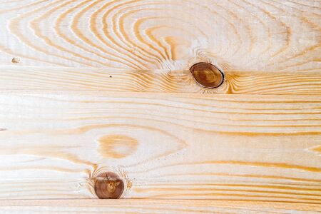 Light wooden background. Natural wood pattern with dark, cracked knots. For your design, template, sample.の写真素材