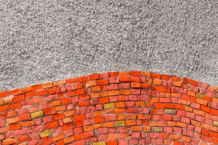 Fragment of building wall with decorative mosaics. Background two colors of rich intense red smalt and grey empty part. For Your Design of Templates Postcards Decoration with space to Text.の写真素材