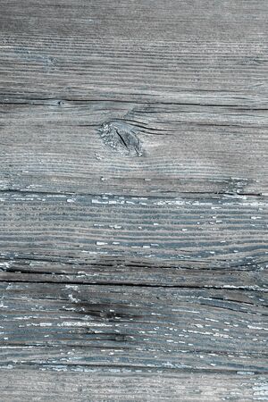 Old cracked boards with peeling blue paint. Natural grunge wood texture for your design close up. Village background.の写真素材