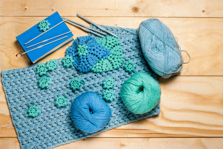 Composition of crocheted blue-green openwork napkins and equipment for knitting with copy space....