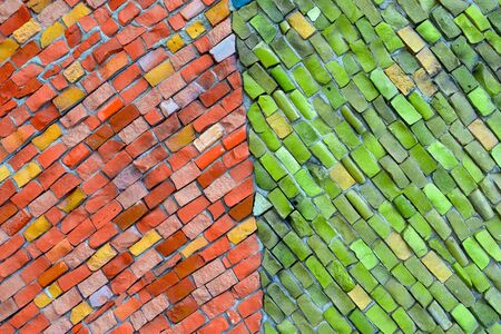 Surface of walls with decorative mosaics of red and green. abstract background with copy space and place for text, design. Fashion texture, minimal concept.の写真素材