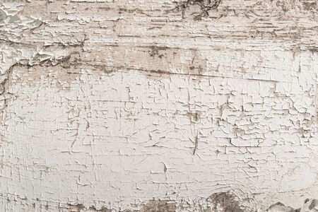Texture of wood panel with old peeling cracked weathered white paint close up with cracks and scratches. Background abstract pattern as background for your design with copy space and place for text.の写真素材