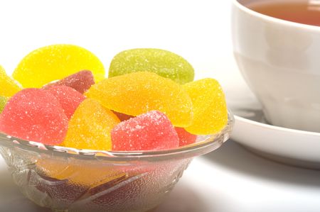 Fruit candy and tea cup. It is isolated on a white background の写真素材