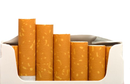 Open a pack of filtered cigarettes closeup isolated on a white background.の写真素材