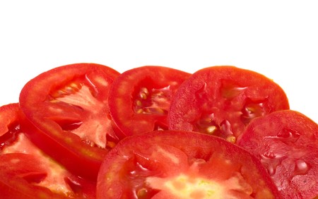 Cut tomato closeup on a white background.の写真素材