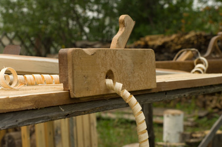 Closeup shot of old wooden plane on the workbench.