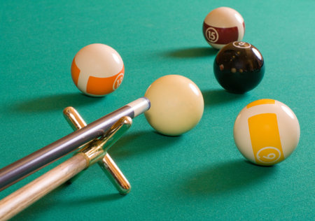 Cue and pool balls on a billiard table.の写真素材
