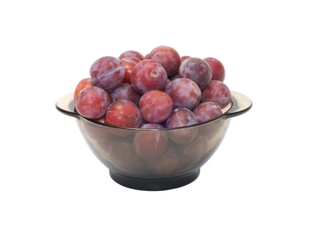 Ripe plums on a plate isolated on a white background.の写真素材