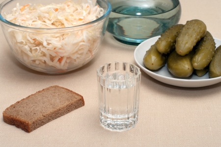Wine-glass of vodka pickles and sauerkraut close up.の写真素材