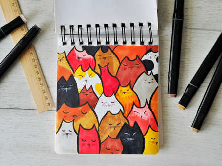 Sketch of cat pattern on wooden background with markersの写真素材