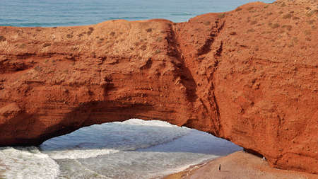 Close-up of natural giant arch and a small manの写真素材
