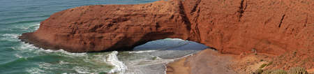 Panoramic view of giant natural arch on seaside beachの写真素材