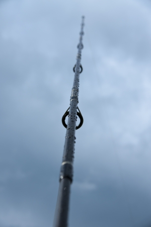 Fisherman sport hobby fishing rod or spinning reel on sea beach sunset の写真素材