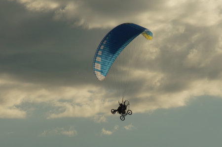 A paraglider on a flight in the clear sky