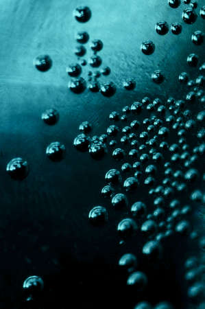 blue Magical air bubbles in a dark space with a metallic glowの写真素材