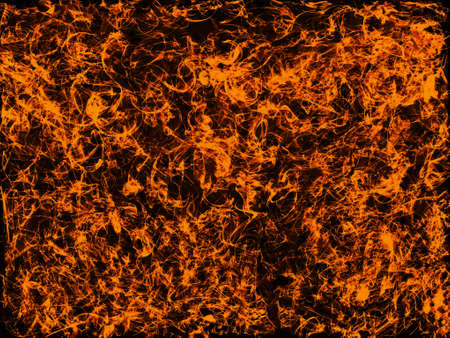 Fiery blast - bright, strong flames seen from above against a dark backgroundの写真素材