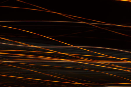 Luminous streamer - neon bright lines on black background.