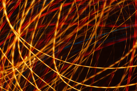 Luminous streamer - neon bright lines on black background.