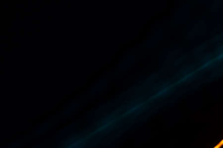Luminous streamer - neon bright lines on black background.の写真素材