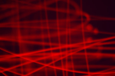 Red smeared luminous neon on black background. Irregular lines of energy in space. Composition of...