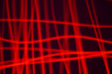 Red smeared luminous neon on black background. Irregular lines of energy in space. Composition of...