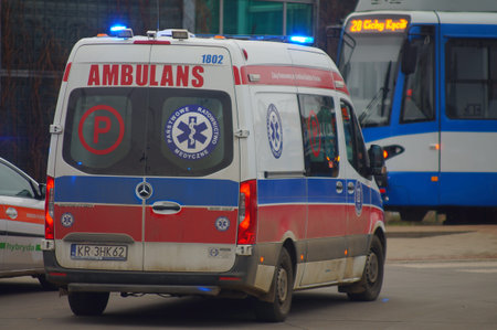 Accident involving streetcar and passenger - police, medical and traffic police cars. The place of the incident in Krakow - streetcar terminus Maly PÅaszow. Krakow, Poland - 03/11/2021のeditorial素材