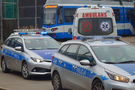 Accident involving streetcar and passenger - police, medical and traffic police cars. The place of the incident in Krakow - streetcar terminus Maly PÅaszow. Krakow, Poland - 03/11/2021のeditorial素材