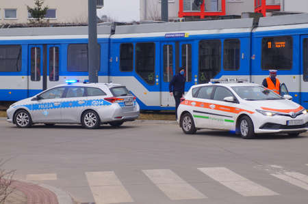Accident involving streetcar and passenger - police, medical and traffic police cars. The place of the incident in Krakow - streetcar terminus Maly PÅaszow. Krakow, Poland - 03/11/2021のeditorial素材