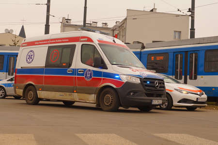 Accident involving streetcar and passenger - police, medical and traffic police cars. The place of the incident in Krakow - streetcar terminus Maly PÅaszow. Krakow, Poland - 03/11/2021のeditorial素材