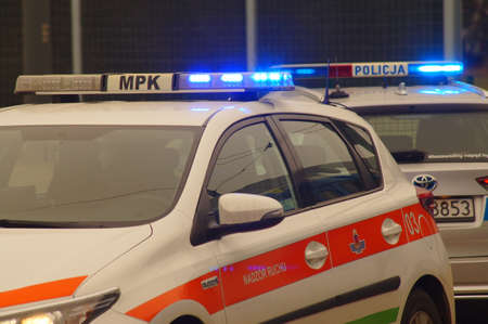 Krakow, Poland - 03/11/2021: Traffic accident, intervention of Polish police and medical services. Police car and ambulance at the signal. Removing the consequences of the accident. Assistance to victims.のeditorial素材