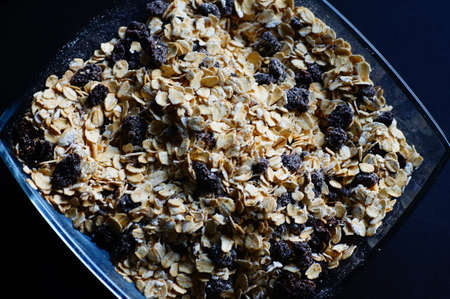 Oatmeal with raisins, cinnamon and milk. Food for athletes, vegetarians and dieters.の写真素材
