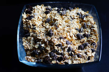 Oatmeal with raisins, cinnamon and milk. Food for athletes, vegetarians and dieters.の写真素材