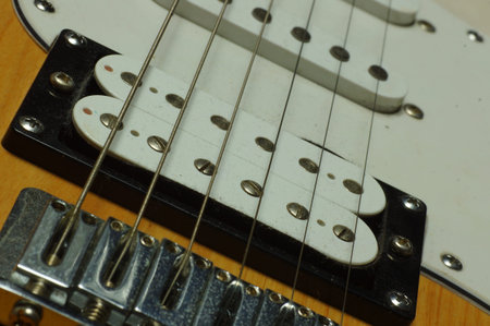 Electric guitar. Close up view of the strings and the fretboard.