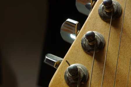 Detail of the neck of an electric guitar on a dark backgroundの写真素材