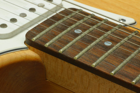 Acoustic guitar in a wooden box close-up on a wooden background