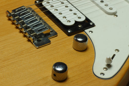 Electric guitar on a wooden background. Close-up. Selective focus.