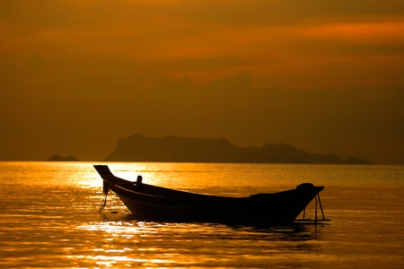 A Boat float on the sea in Sunset time at Koh Samui, Thailandの写真素材