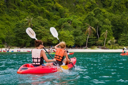 traveler kayaking in the thai ocean from backward viewの写真素材