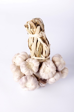 bundle of garlic isolated on white backgroundの写真素材