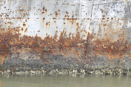 Abstract section of rusted metallic boarding that was used to protect machinery from sea winds.の写真素材