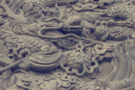 dragon statue on chinese taoism temple wallの写真素材