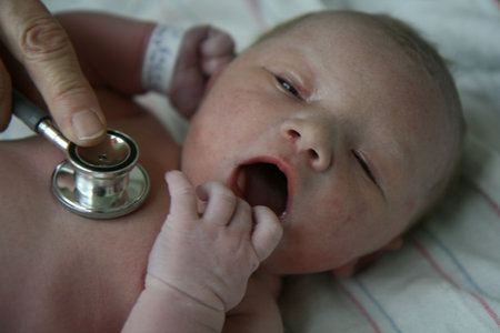 this is a newborn getting her heart beat checked with a stethoscope   in the first hour