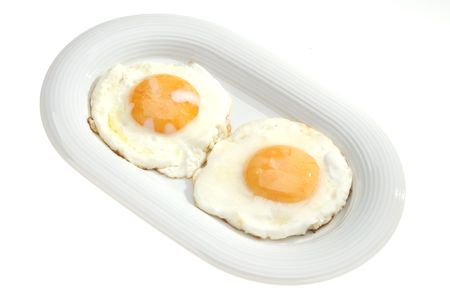 A pair of eggs on the plateの写真素材