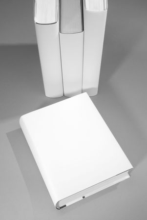 Blank book cover w background of a row of booksの写真素材