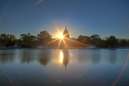 U.S. Capitol at sunrise mirroring in the waterの写真素材