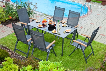The metal Garden furniture by the house and the poolの写真素材