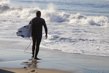 Santa Cruz, USA, November 25, 2014: Athlete surfing on Santa Cruz beach in California. November 25, 2014のeditorial素材