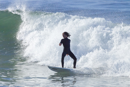 Santa Cruz, USA, November 25, 2014: Athlete surfing on Santa Cruz beach in California. November 25, 2014のeditorial素材